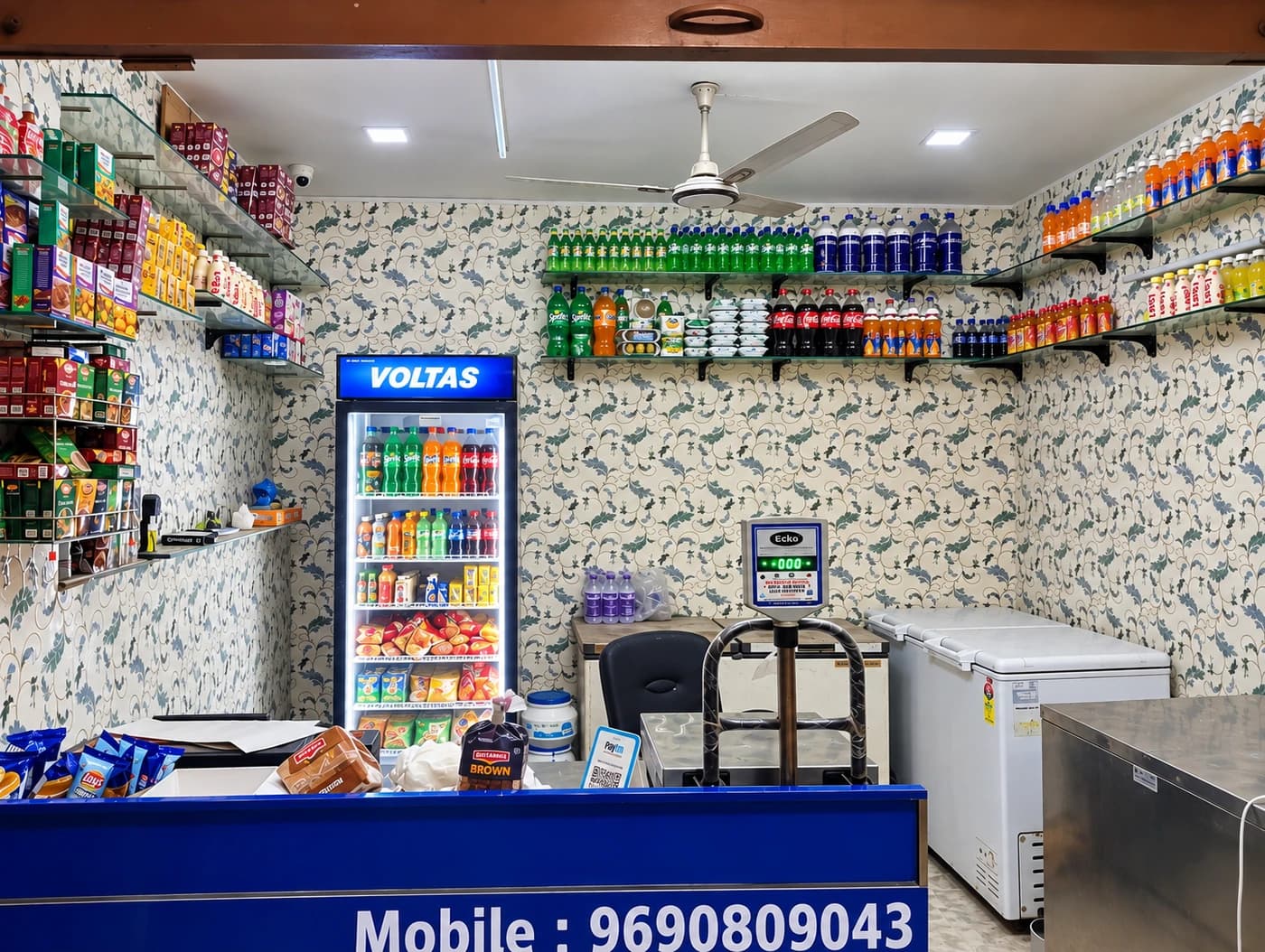 Inside Deewan G Dairy physical shop floor, stainless counters, and refrigeration in East of Kailash